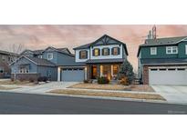 Charming two-story home featuring stone accents, a well-manicured lawn, and an attached two-car garage at 14845 Haley Ave, Parker, CO 80134