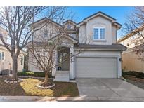 Charming two-story home with a well-manicured front yard and a two-car garage, perfect for suburban living at 11989 E Lake Cir, Greenwood Village, CO 80111