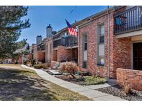 Brick condo units showcase charming front patios and balconies with beautiful landscaping and walkways at 4194 S Fraser Way # B, Aurora, CO 80014