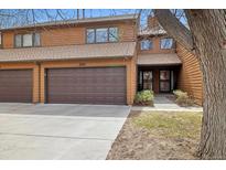 Inviting two-story townhouse featuring a private garage and a charming front entrance with beautiful wood siding at 2263 E 129Th Ave, Thornton, CO 80241