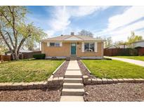 Charming brick home featuring a well-manicured lawn and inviting walkway at 10500 Marion St, Northglenn, CO 80233