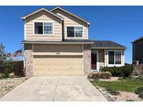 Charming two-story home featuring a brick-accented garage, well-kept lawn, and an American flag waving in the yard at 4915 Parsons Way, Castle Rock, CO 80104