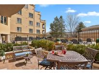 Inviting patio with comfortable seating, perfect for outdoor relaxation and entertaining with lush landscaping around it at 2500 E Cherry Creek South Dr # 116, Denver, CO 80209