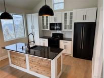 Modern kitchen features stainless steel appliances, granite countertops, and an island at 33884 Bergen View Trl, Evergreen, CO 80439