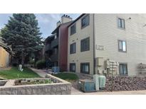 The exterior shows the building, sidewalk, and landscaping of this residence at 10890 W Evans Ave # 2E, Lakewood, CO 80227
