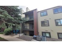 Inviting condo exterior featuring balconies, neutral siding, and well-maintained landscaping at 10890 W Evans Ave # 2E, Lakewood, CO 80227