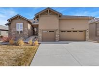 Beautiful two-story home with a three car garage and stone and stucco exterior at 15720 Columbus Mountain Dr, Broomfield, CO 80023