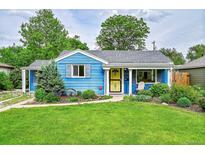 Charming blue bungalow featuring a well-manicured lawn and inviting front porch at 1720 Trenton St, Denver, CO 80220
