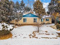 Ranch style home with a brick facade and mature landscaping at 4035 E 16Th Ave, Denver, CO 80220