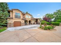 Stunning stucco home with stone accents, a water fountain, and a basketball court at 6783 E Orchard Rd, Greenwood Village, CO 80111