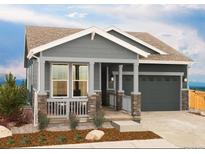 Charming single-Gathering home boasting a welcoming front porch with stylish stone accents and a two-car garage at 21085 E 61St Dr, Aurora, CO 80019
