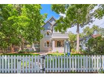 Charming home featuring a well-manicured lawn and a classic white picket fence at 2215 S Columbine St, Denver, CO 80210