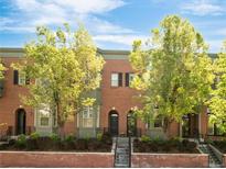 Charming brick townhome with manicured landscaping and inviting front entryway at 2958 N Xenia St, Denver, CO 80238