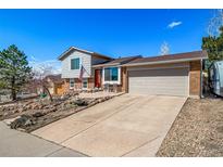 Charming two-story home with a well-maintained yard, concrete driveway, and attached two-car garage at 2159 Beacham Dr, Castle Rock, CO 80104