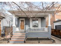 Charming gray painted home with a cozy front porch, featuring updated wooden steps and classic architectural details at 2427 W Argyle Pl, Denver, CO 80211