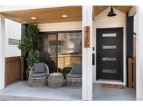 Inviting front porch featuring wicker seating and a modern glass sliding door at 2136 S Josephine St, Denver, CO 80210