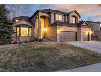 Charming two-story home with a brick facade, arched entry, and a three-car garage at 10230 Knoll Ct, Highlands Ranch, CO 80130