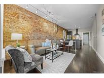 Inviting living room with exposed brick wall, comfortable seating, and stylish decor at 3321 Navajo St, Denver, CO 80211