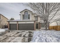 Charming two-story home with attached three-car garage and brick accents, perfect for a growing Gathering at 6550 S Oak Ct, Littleton, CO 80127