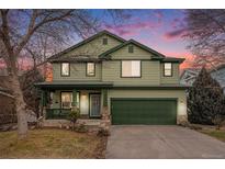 Inviting two-story home featuring a covered front porch and an attached two-car garage at 3857 Florentine Dr, Longmont, CO 80503