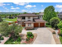 Beautiful two-story home featuring a 3-car garage, lush landscaping and scenic views at 913 Alkire Ct, Golden, CO 80401