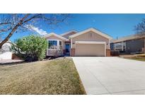 Charming home with a well-manicured lawn, large driveway, and inviting facade at 1229 Berganot Trl, Castle Pines, CO 80108