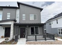 Contemporary two-story home with a modern design and inviting front porch, enhancing curb appeal at 14586 W 91St Ave # A, Arvada, CO 80005
