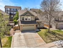 Charming two-story home with a well-manicured lawn and a large driveway leading to a two-car garage at 2602 E 145Th Ave, Thornton, CO 80602