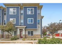 Modern townhome with blue and gray exterior, stone accents, and well-maintained landscaping at 9300 E Florida Ave # 1101, Denver, CO 80247