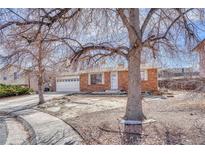 Charming brick home with a well-maintained front yard and mature trees at 2675 S Carson Way, Aurora, CO 80014