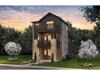 Charming new construction home with a three-story façade, multiple balconies, and stone accents at 8631 Hotchkiss St, Littleton, CO 80125