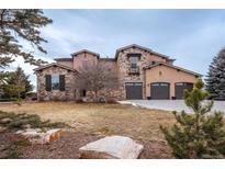 Two-story house with stone accents and a three-car garage at 2543 Eastview Dr, Castle Rock, CO 80104