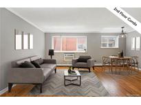 Bright living room features hardwood floors, modern gray furnishings, and contemporary decor at 1242 Gaylord St # 101, Denver, CO 80206