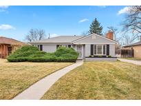 Charming single-story home featuring a landscaped front yard with walkway leading to the front door at 1030 Krameria St, Denver, CO 80220