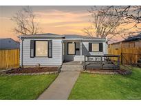 Charming single-story home with a well-maintained lawn, sidewalk and a cozy front porch at 1615 S Elizabeth St, Denver, CO 80210