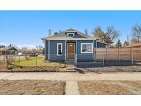 Charming blue home with a fenced yard, stone walkway, and a welcoming front door at 3300 W 2Nd Ave, Denver, CO 80219