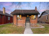 Charming brick home with well-maintained lawn and inviting entrance at 4344 Wyandot St, Denver, CO 80211