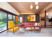 Well lit living room showcasing contemporary furnishings and a view to the outdoors at 3650 Chimayo Rd, Littleton, CO 80123