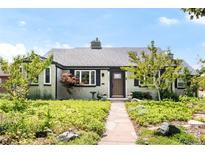 Charming single-story home with manicured front yard landscaping and a stone walkway leading to the front door at 1185 Glencoe St, Denver, CO 80220