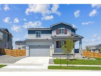 Charming two-story home with a well-manicured lawn and a welcoming front porch at 10065 Quari Ct, Commerce City, CO 80022
