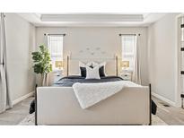 Bright bedroom features a neutral palette, plush bedding, and accent lighting for a comfortable and inviting space at 21893 E Tufts Cir, Aurora, CO 80015