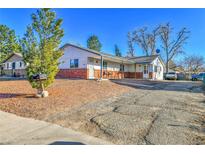 Charming single-story home featuring a brick facade and well-maintained landscaping at 16608 E 13Th Ave, Aurora, CO 80011
