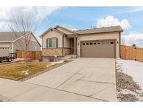 Attractive house exterior with a tan color scheme and driveway at 27957 E 9Th Dr, Aurora, CO 80018