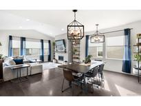 Spacious living room featuring a cozy fireplace and ample natural light at 9392 Anvil St, Arvada, CO 80007