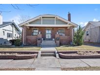 Charming brick home with inviting front porch and well-maintained landscaping at 772 Garfield St, Denver, CO 80206