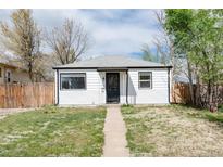 Charming single story home showcasing its tidy front yard and classic white exterior at 1941 Wabash St, Denver, CO 80220