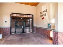 Secured entrance to Village Lofts features brick accents and gated access for added safety and peace of mind at 5677 S Park Pl # C208, Englewood, CO 80111