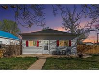 Charming single story home with red shutters and inviting front patio under a twilight sky at 257 2Nd St, Frederick, CO 80530