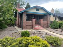 Charming brick home with a cozy front porch and colorful landscaping at 1881 S Lincoln St, Denver, CO 80210