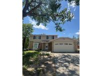 Charming two-story home featuring neutral siding, an attached two car garage, and a well-maintained lawn at 10611 Holland St, Broomfield, CO 80021